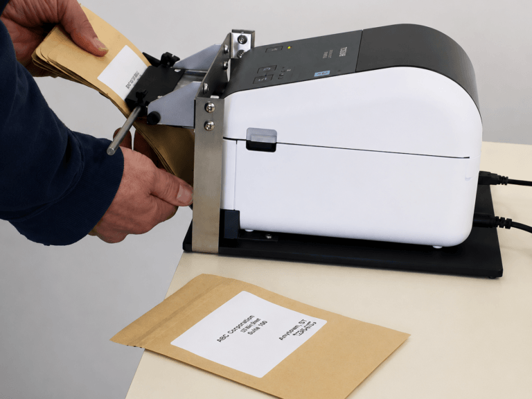 PrinterZip Z10 being used to apply labels to envelopes