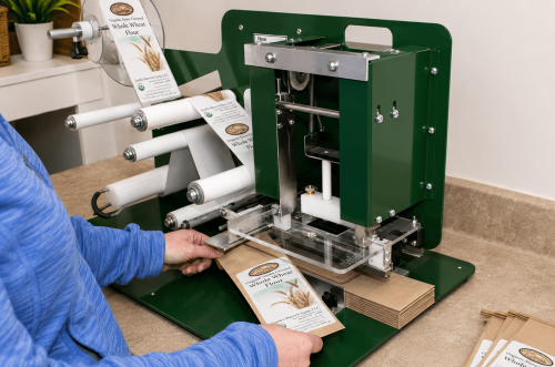 image of woman applying labels with semi automatic label applicator machine